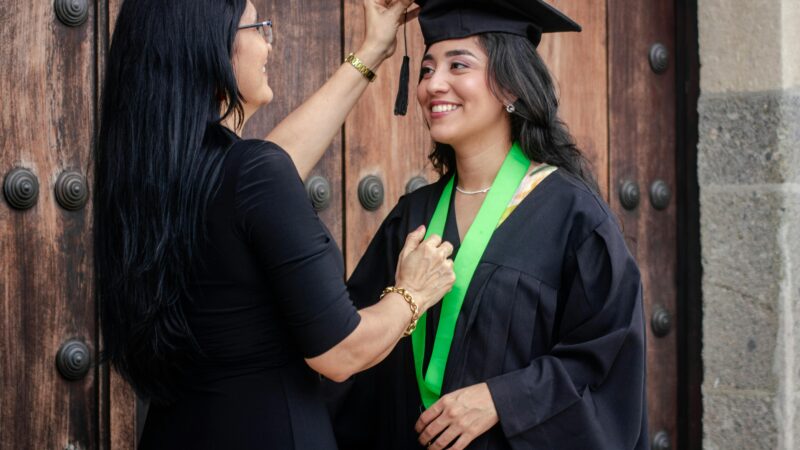 Woman Fixing the Mortarboard on her Daughters Head