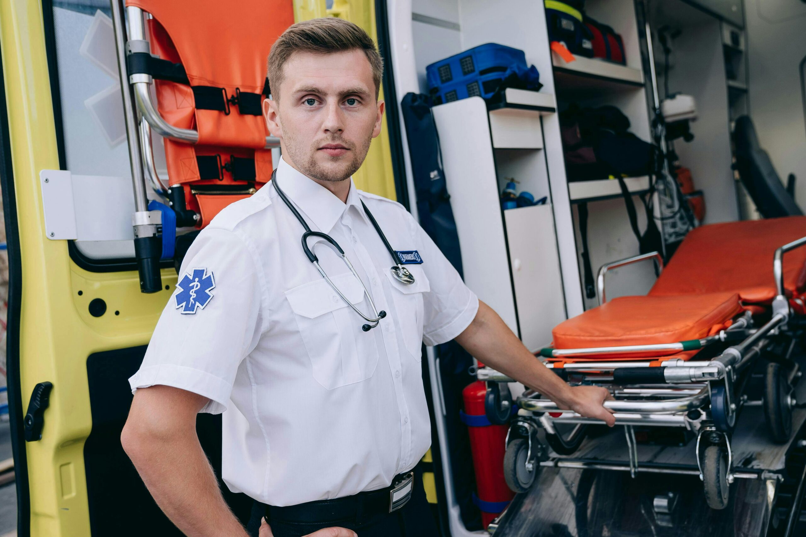 Paramedic Pulling a Gurney Out of an Ambulance